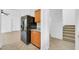 Partial view of kitchen featuring wooden cabinets and black appliances, adjacent to stairway at 110 N 66Th Ave, Phoenix, AZ 85043