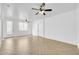 Bright and airy living room with light-colored herringbone flooring and multiple entryways at 110 N 66Th Ave, Phoenix, AZ 85043