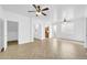 Expansive living area showcasing light-colored herringbone flooring and arched doorways at 110 N 66Th Ave, Phoenix, AZ 85043