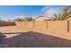 View of a spacious backyard with a block fence and landscaping possibilities at 1236 E Silver Reef Dr, Casa Grande, AZ 85122