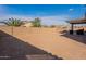 Large backyard with a block fence, covered patio, and plenty of space for customization at 1236 E Silver Reef Dr, Casa Grande, AZ 85122