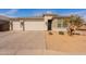 View of the home, showing the driveway, front door, and well-maintained landscaping at 1236 E Silver Reef Dr, Casa Grande, AZ 85122