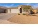 Inviting home featuring a three car garage, stone accents, and charming curb appeal at 1236 E Silver Reef Dr, Casa Grande, AZ 85122