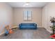 Bright and spacious living room with a stylish blue sofa and modern flooring at 1236 E Silver Reef Dr, Casa Grande, AZ 85122