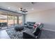 Relaxing living room area with a large gray leather couch and a sliding glass door to the patio at 1236 E Silver Reef Dr, Casa Grande, AZ 85122