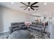 Spacious living room features a large gray leather couch and a decorative ceiling fan at 1236 E Silver Reef Dr, Casa Grande, AZ 85122