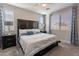 This cozy main bedroom features stylish furniture, blue and white bedding, and natural light from multiple windows at 1236 E Silver Reef Dr, Casa Grande, AZ 85122