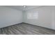 Bright bedroom with wood grain flooring, white walls, a ceiling fan, and a window at 12408 N Cherry Hills W Dr, Sun City, AZ 85351