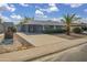 Charming single-story home features a spacious driveway, xeriscape landscaping, and inviting curb appeal at 12408 N Cherry Hills W Dr, Sun City, AZ 85351