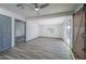 Spacious living room featuring a ceiling fan, wood flooring, and sliding glass doors at 12408 N Cherry Hills W Dr, Sun City, AZ 85351