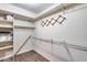 Empty closet featuring vinyl wood flooring and adjustable metal shelving at 12515 W Prospect Dr, Sun City West, AZ 85375