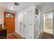 Bright entryway featuring hardwood floors, an orange door, and a glimpse into other rooms at 12515 W Prospect Dr, Sun City West, AZ 85375