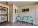 Welcoming front porch with decorative iron door, outdoor seating, and ample natural light at 12515 W Prospect Dr, Sun City West, AZ 85375