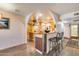 Bright open kitchen with a breakfast bar, stainless hood, and wood-look vinyl plank flooring at 12515 W Prospect Dr, Sun City West, AZ 85375