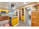 Bright open kitchen featuring stainless steel appliances, wood-look vinyl plank flooring, and custom cabinets at 12515 W Prospect Dr, Sun City West, AZ 85375