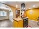 Bright kitchen featuring butcher block countertop on the center island, stainless steel range hood and oven at 12515 W Prospect Dr, Sun City West, AZ 85375