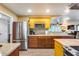 Bright open kitchen features stainless steel appliances, custom cabinets, and wood-look vinyl plank flooring at 12515 W Prospect Dr, Sun City West, AZ 85375