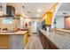 Spacious kitchen featuring stainless appliances, granite countertops, and wood-look vinyl plank flooring at 12515 W Prospect Dr, Sun City West, AZ 85375