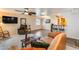 Bright living room with a skylight, leather sofa, and a bar area that adds character to the home at 12515 W Prospect Dr, Sun City West, AZ 85375