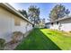 View of a side yard with manicured lawn area and the side of home in neutral color at 12515 W Prospect Dr, Sun City West, AZ 85375