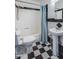 This traditional bathroom has black and white tile, a shower and a pedestal sink at 1301 E Belmont Ave, Phoenix, AZ 85020