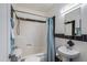 This traditional bathroom has black and white tile, a shower and a pedestal sink at 1301 E Belmont Ave, Phoenix, AZ 85020