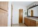 This bathroom features a wooden vanity, framed mirror and wooden cabinets providing storage at 1301 E Belmont Ave, Phoenix, AZ 85020