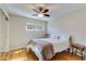 Bright bedroom featuring hardwood floors, a ceiling fan, and natural light from the windows at 1301 E Belmont Ave, Phoenix, AZ 85020