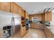 Bright kitchen featuring stainless steel appliances, granite countertops, and wooden cabinetry at 1301 E Belmont Ave, Phoenix, AZ 85020