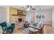 Cozy living room featuring fireplace, ceiling fan, and sliding glass door at 1301 E Belmont Ave, Phoenix, AZ 85020