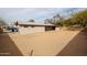 Wide view of the backyard, featuring desert landscaping and a covered patio area at 13439 N 16Th Ave, Phoenix, AZ 85029