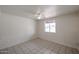 Bedroom showcasing neutral walls, tile floor, and a bright window overlooking neighborhood at 13439 N 16Th Ave, Phoenix, AZ 85029