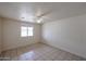 Bright bedroom featuring a ceiling fan, window, and tiled floor at 13439 N 16Th Ave, Phoenix, AZ 85029