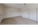 Bedroom with tile floor, ceiling fan, closet and door to the exterior at 13439 N 16Th Ave, Phoenix, AZ 85029