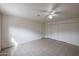 Bedroom featuring tiled floors, closet space, a ceiling fan and light paint at 13439 N 16Th Ave, Phoenix, AZ 85029