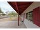 Exterior view of the home's covered porch with red shutters and concrete walkway at 13439 N 16Th Ave, Phoenix, AZ 85029