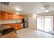 Bright kitchen with stainless steel appliances, wooden cabinets, and breakfast bar at 13439 N 16Th Ave, Phoenix, AZ 85029