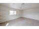 Open living room with tile flooring, a ceiling fan and bright natural light at 13439 N 16Th Ave, Phoenix, AZ 85029