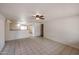 Bright living room with tile flooring, ceiling fan, and neutral walls at 13439 N 16Th Ave, Phoenix, AZ 85029