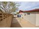 Side yard featuring a block fence, desert landscaping, and a gated entry at 13439 N 16Th Ave, Phoenix, AZ 85029