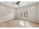 Bright bedroom with hardwood floors, neutral walls, ceiling fan, and a pair of windows with mountain views at 13763 N Campsite Ct, Fountain Hills, AZ 85268