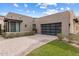 Contemporary home exterior featuring a multi-car garage, desert landscaping, and a paved driveway at 13763 N Campsite Ct, Fountain Hills, AZ 85268