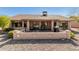 Back of house featuring a BBQ, patio area with chairs, stucco wall and desert landscaping at 14430 W White Rock Dr, Sun City West, AZ 85375