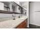 Bathroom with granite countertops, framed mirrors, and sleek fixtures at 14430 W White Rock Dr, Sun City West, AZ 85375