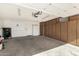 Spacious garage with ample storage cabinetry, and a clean, well-maintained concrete floor at 14430 W White Rock Dr, Sun City West, AZ 85375