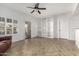 Bright living room with neutral tile, white walls, built-in shelves, and patio access at 14430 W White Rock Dr, Sun City West, AZ 85375