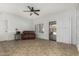 Bright living room with neutral tile, white walls, ceiling fan, and access to the patio at 14430 W White Rock Dr, Sun City West, AZ 85375