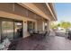 Inviting covered patio with tile floor, dining set, and sliding glass doors for seamless indoor-outdoor living at 14430 W White Rock Dr, Sun City West, AZ 85375