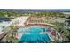 Aerial view of a resort-style community pool and recreation area surrounded by lush landscaping at 14430 W White Rock Dr, Sun City West, AZ 85375