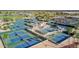 Overhead view of community tennis courts surrounded by palm trees, and greenery at 14430 W White Rock Dr, Sun City West, AZ 85375